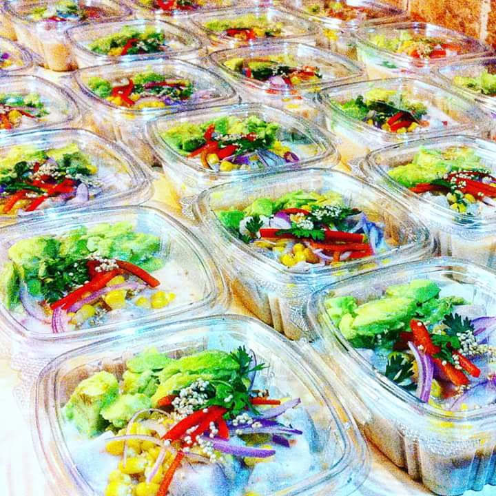 Colorful individual appetizer cups prepared for an event