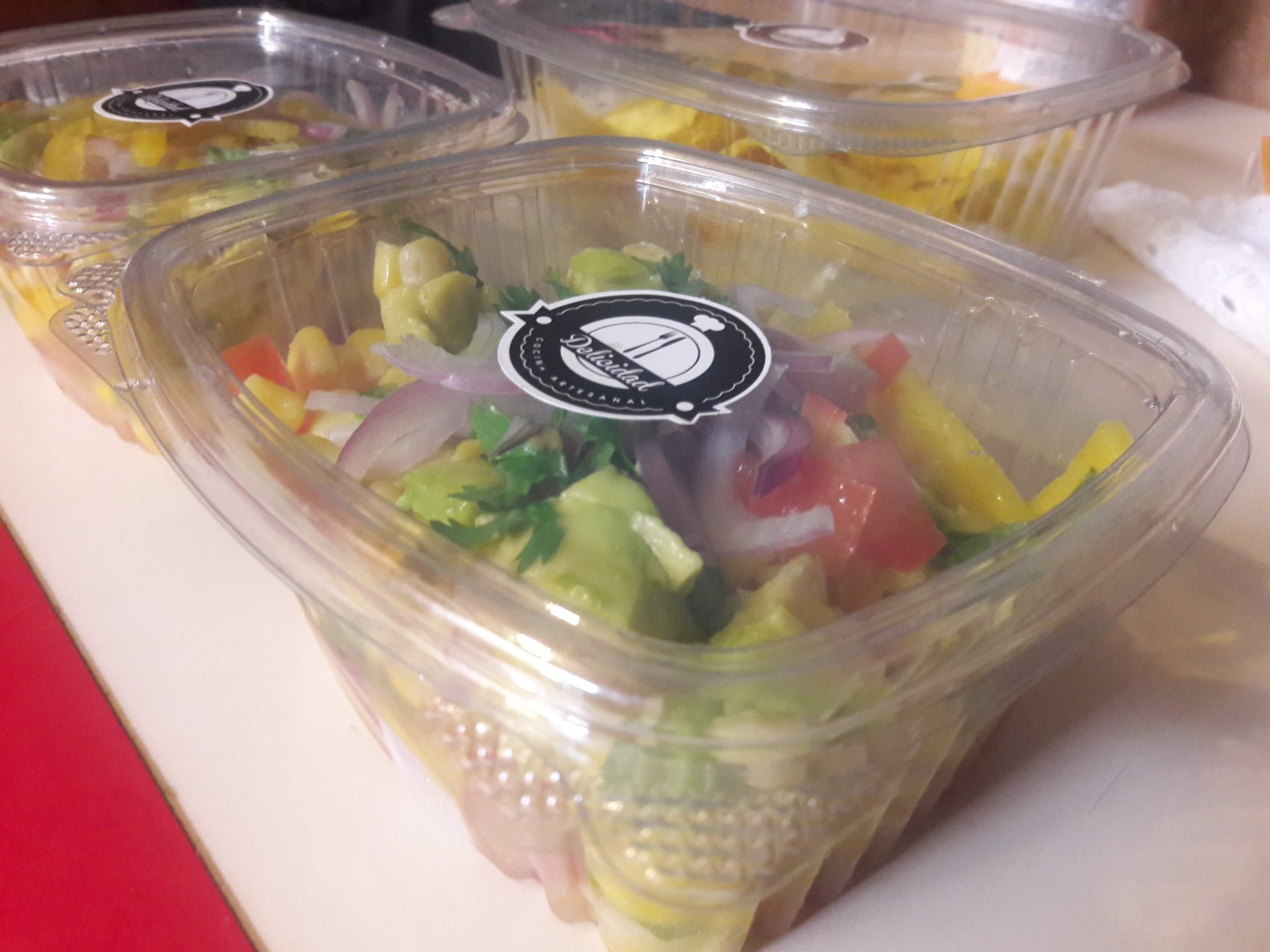 Fresh salads arranged in clear individual catering containers