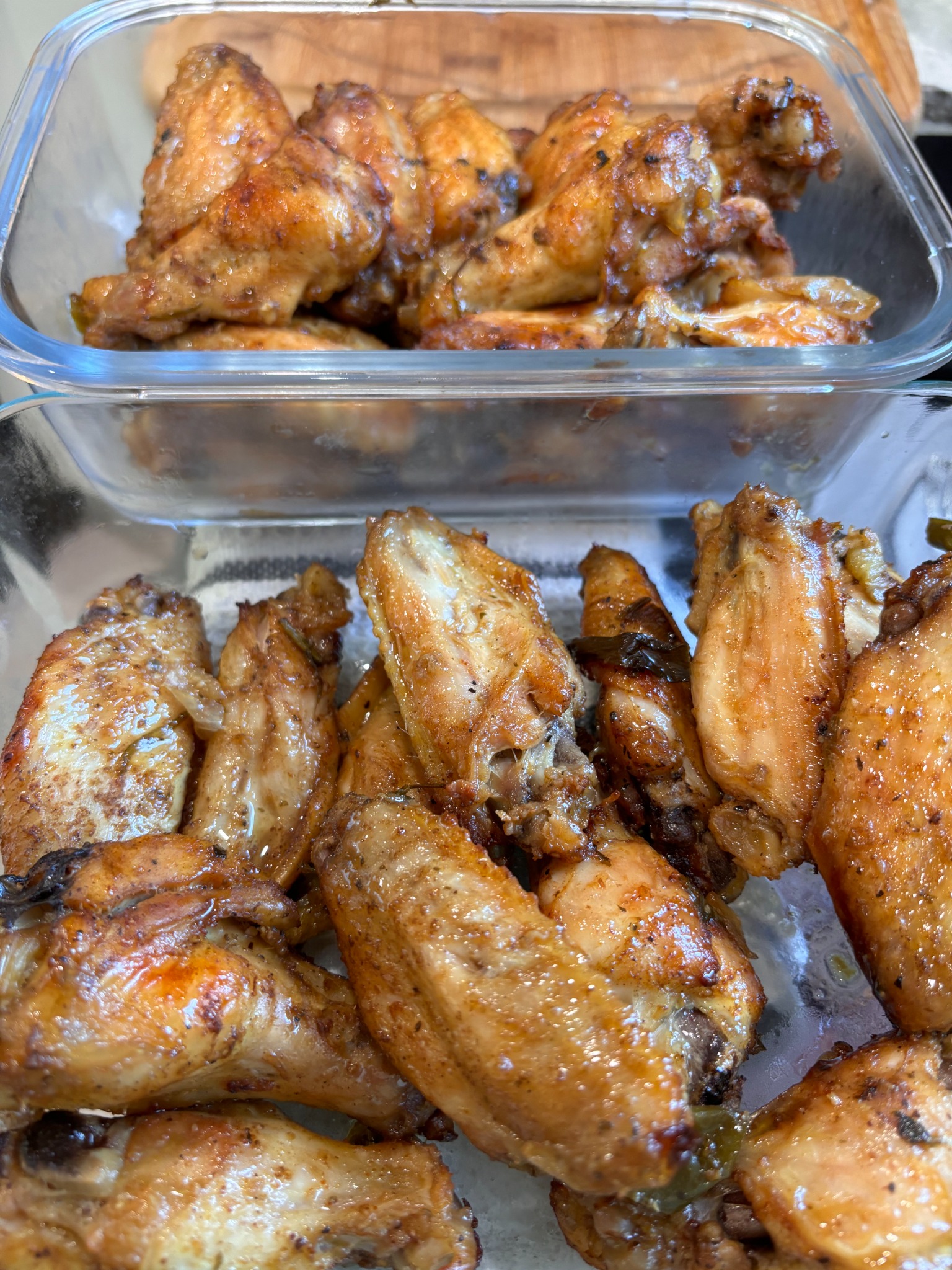 Trays of seasoned roasted chicken prepared for a catered event
