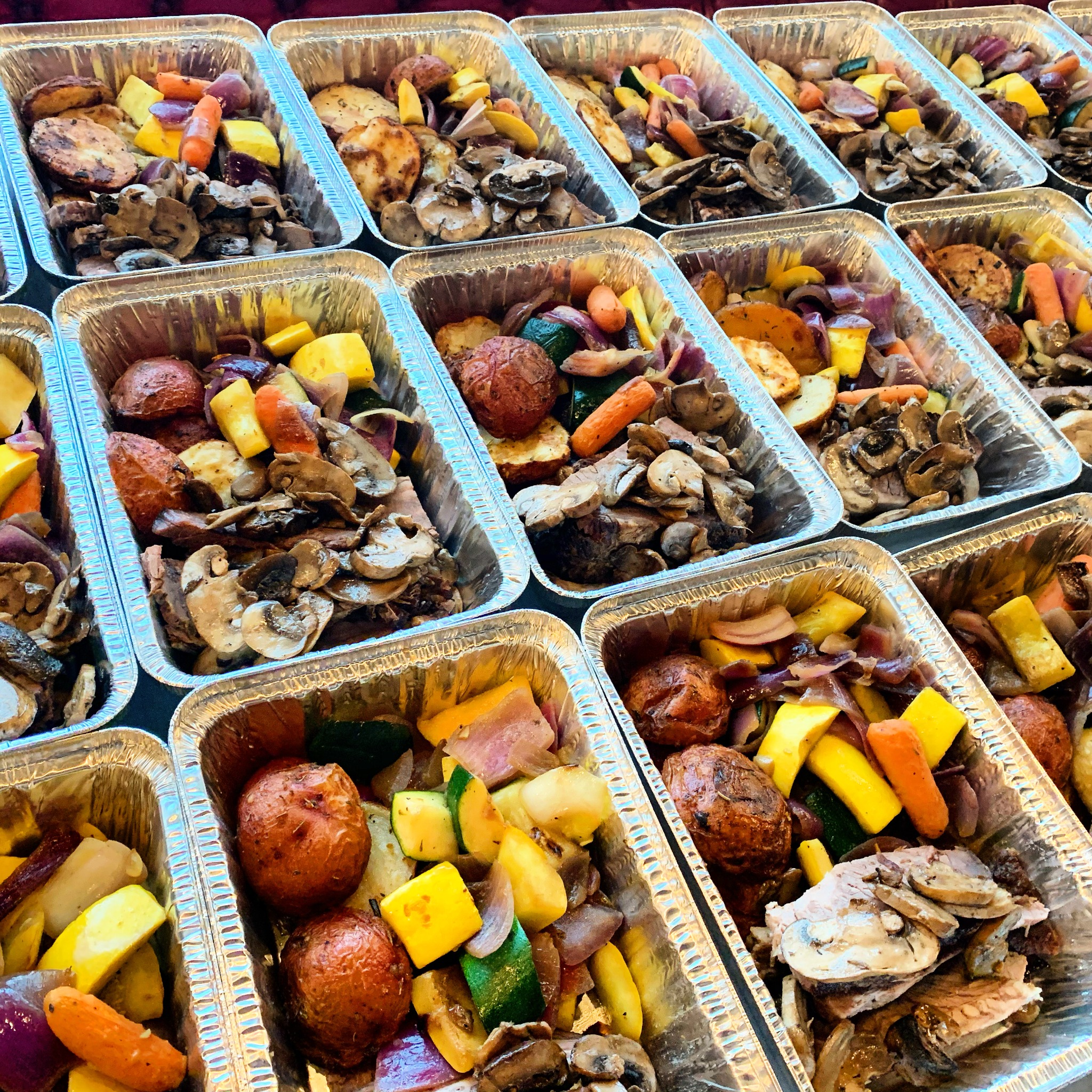 An assortment of portioned proteins and vegetables in meal-prep containers