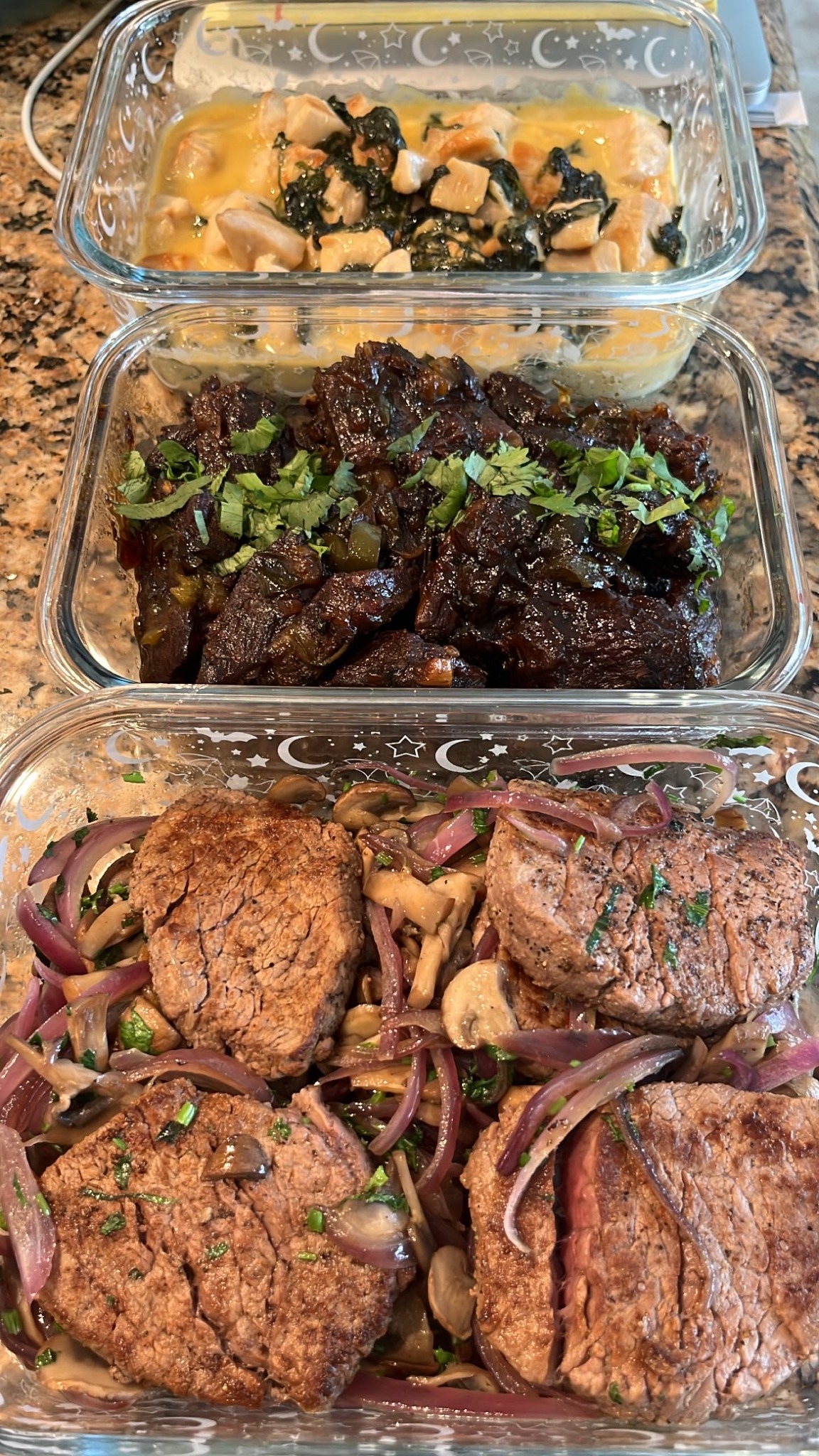 Prepared proteins and side dishes portioned into containers