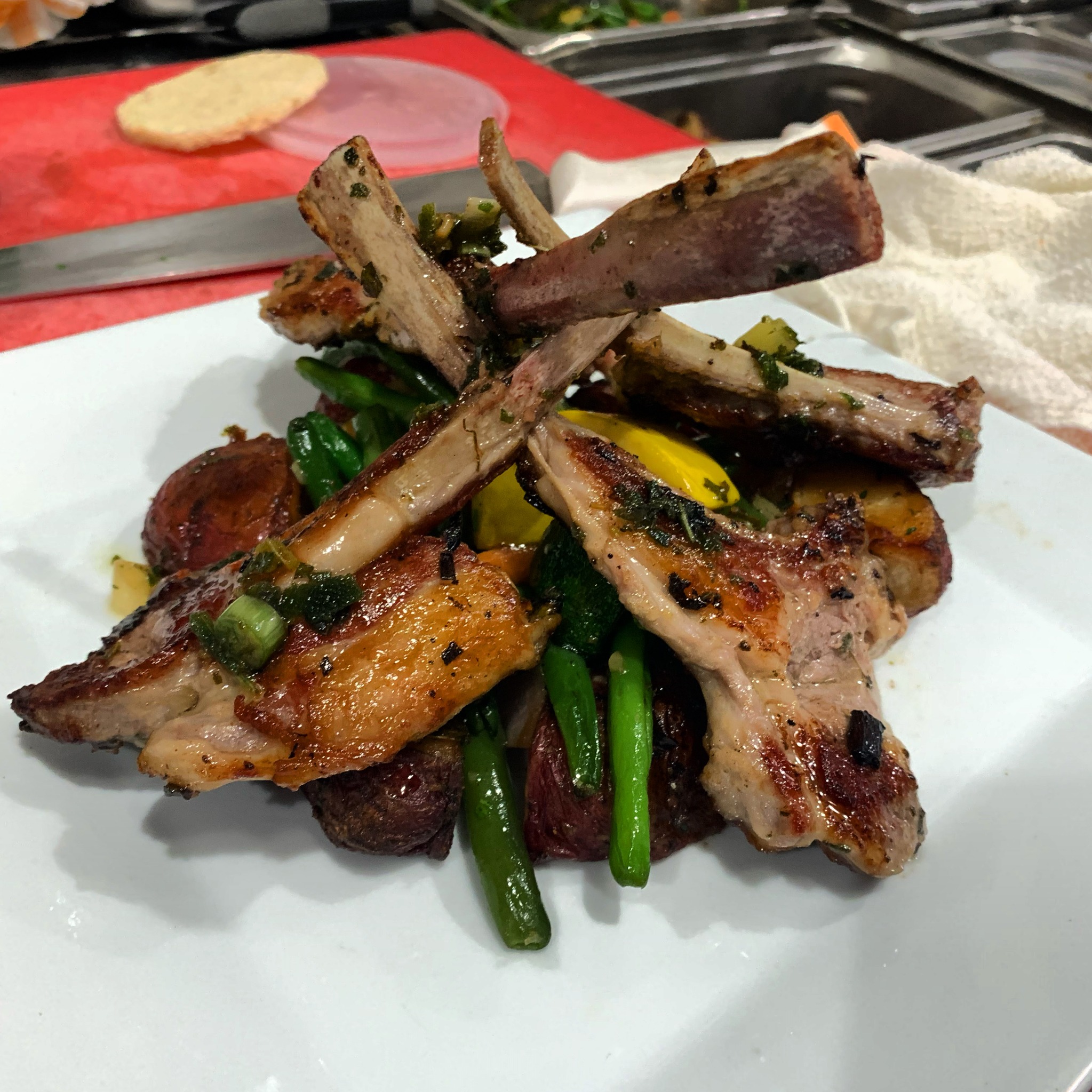 Plated lamb chops with roasted vegetables